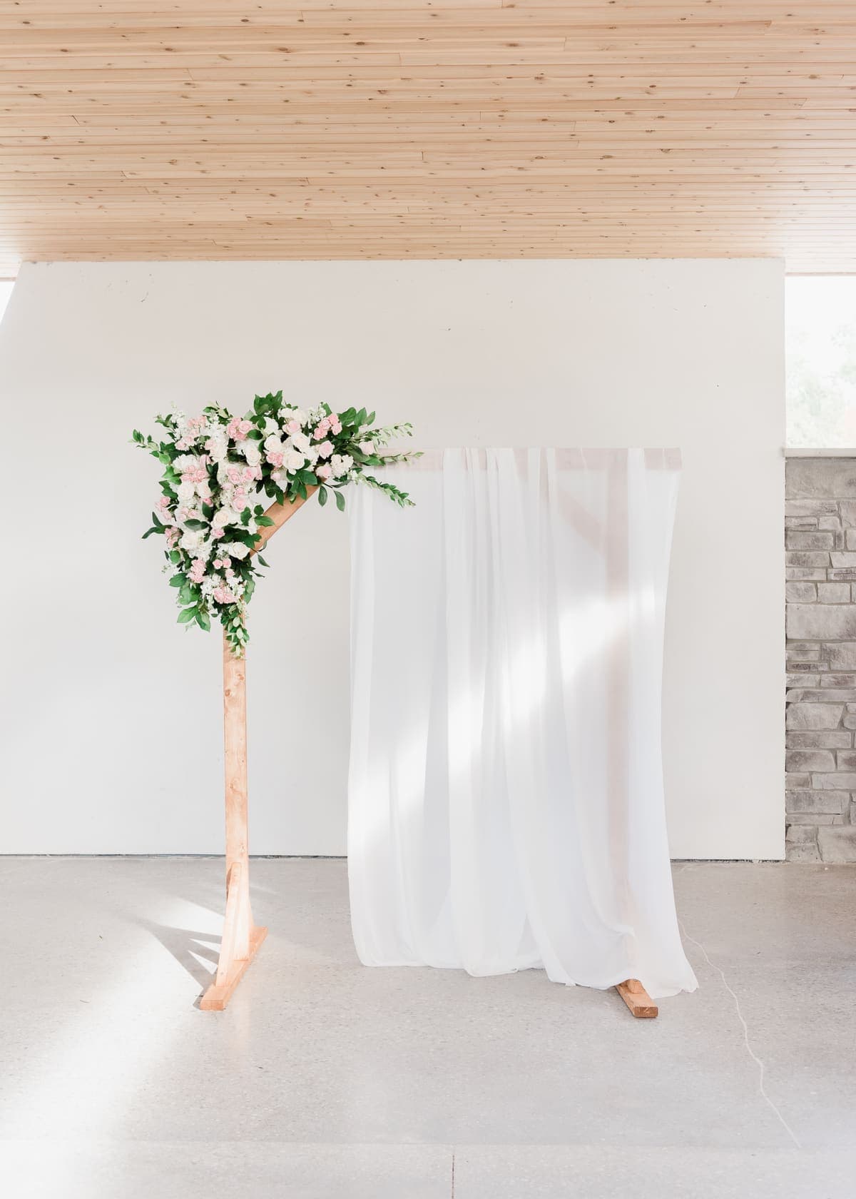 Floral ceremony arch with sheer drapery