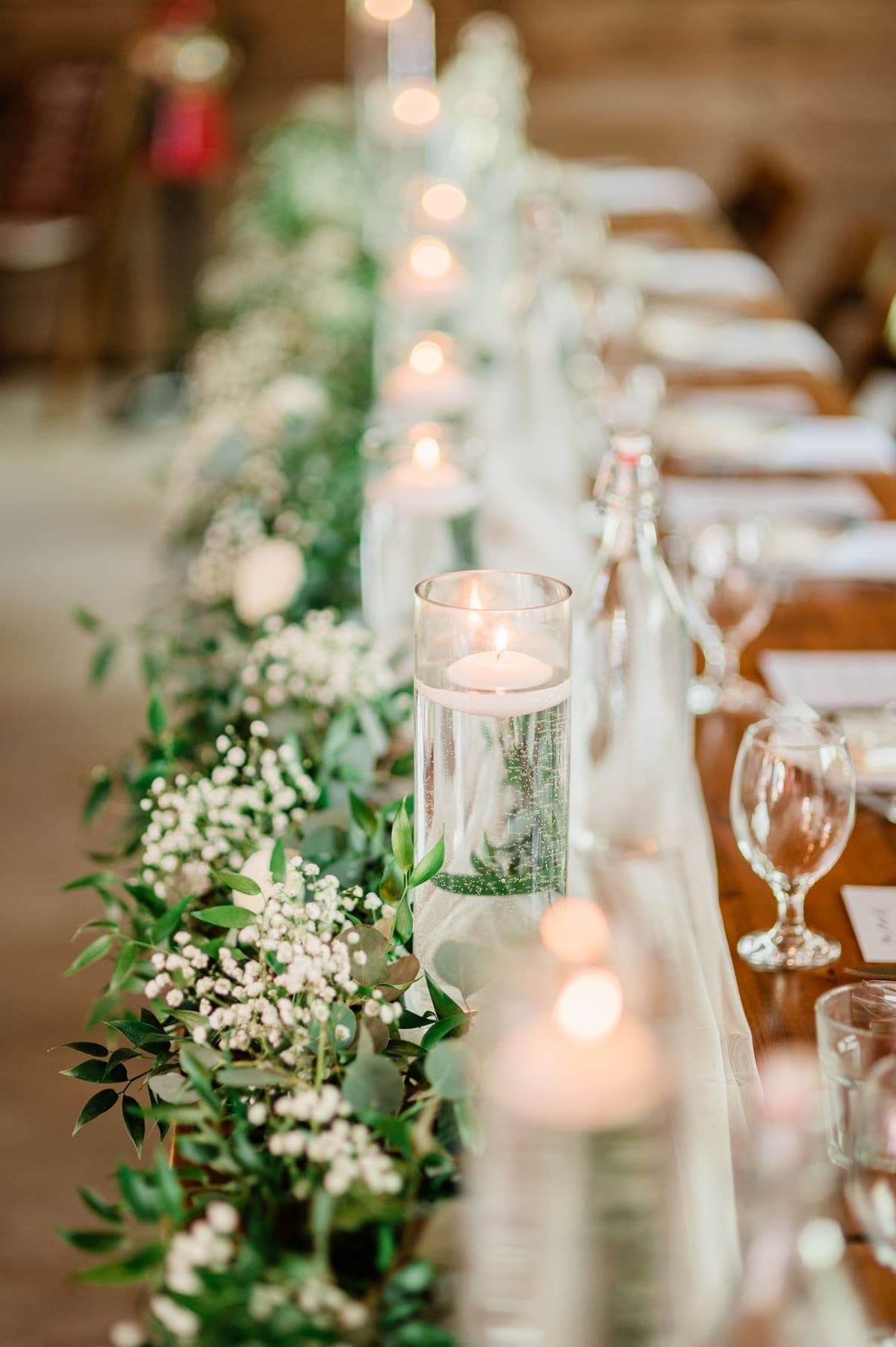Reception table runner with candles and greenery